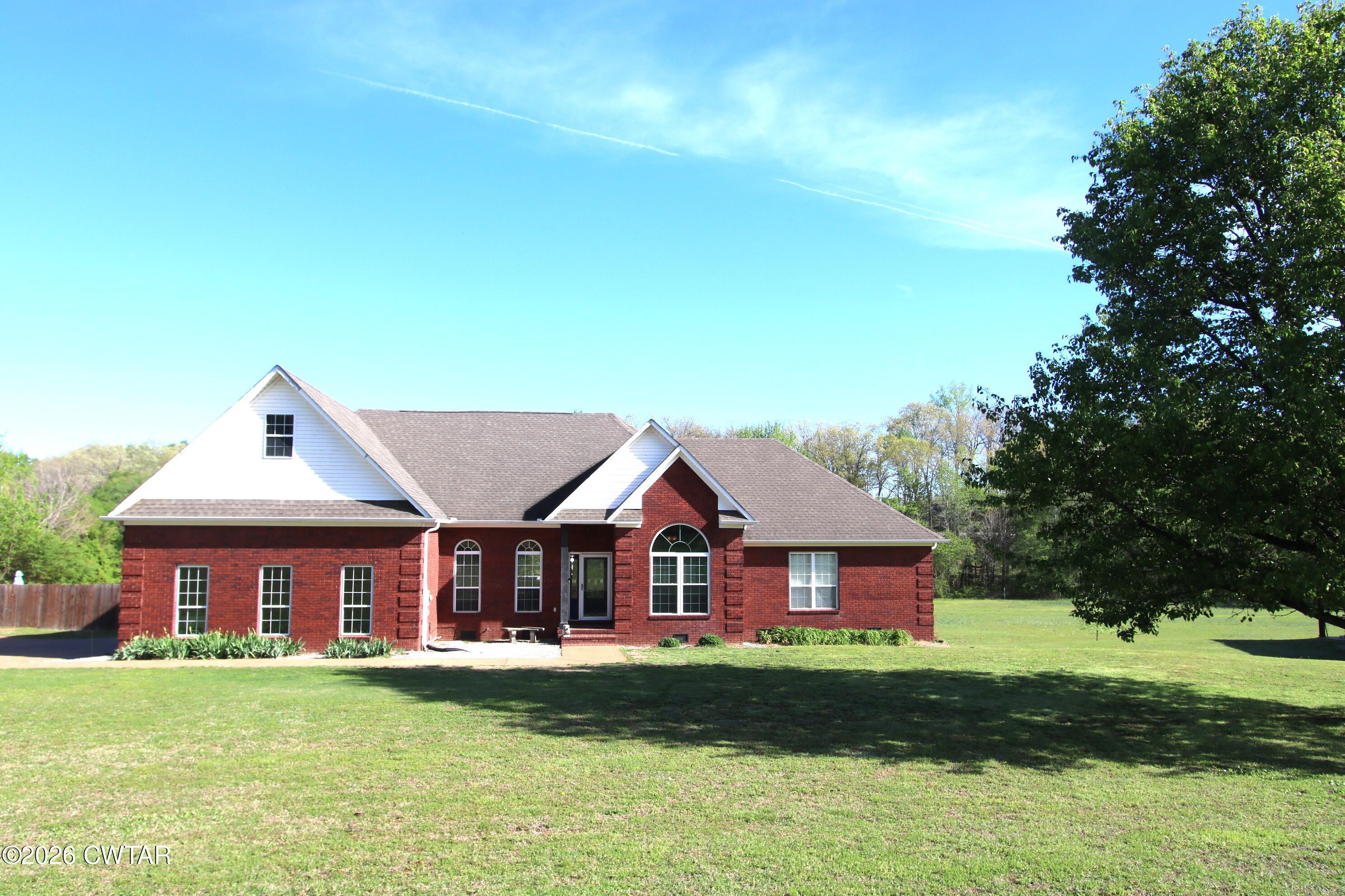 98 Browning Road Milan, TN 38358 - Photo 3 of 59 a view of a house with a big yard plants and large trees