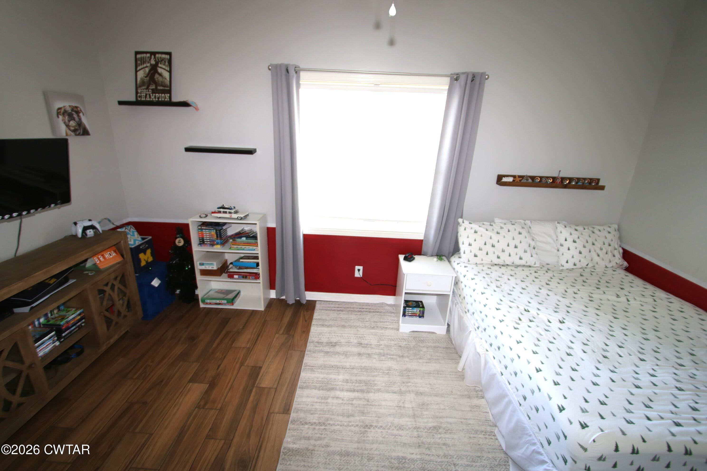 98 Browning Road Milan, TN 38358 - Photo 32 of 59 a bedroom with furniture and a flat tv screen