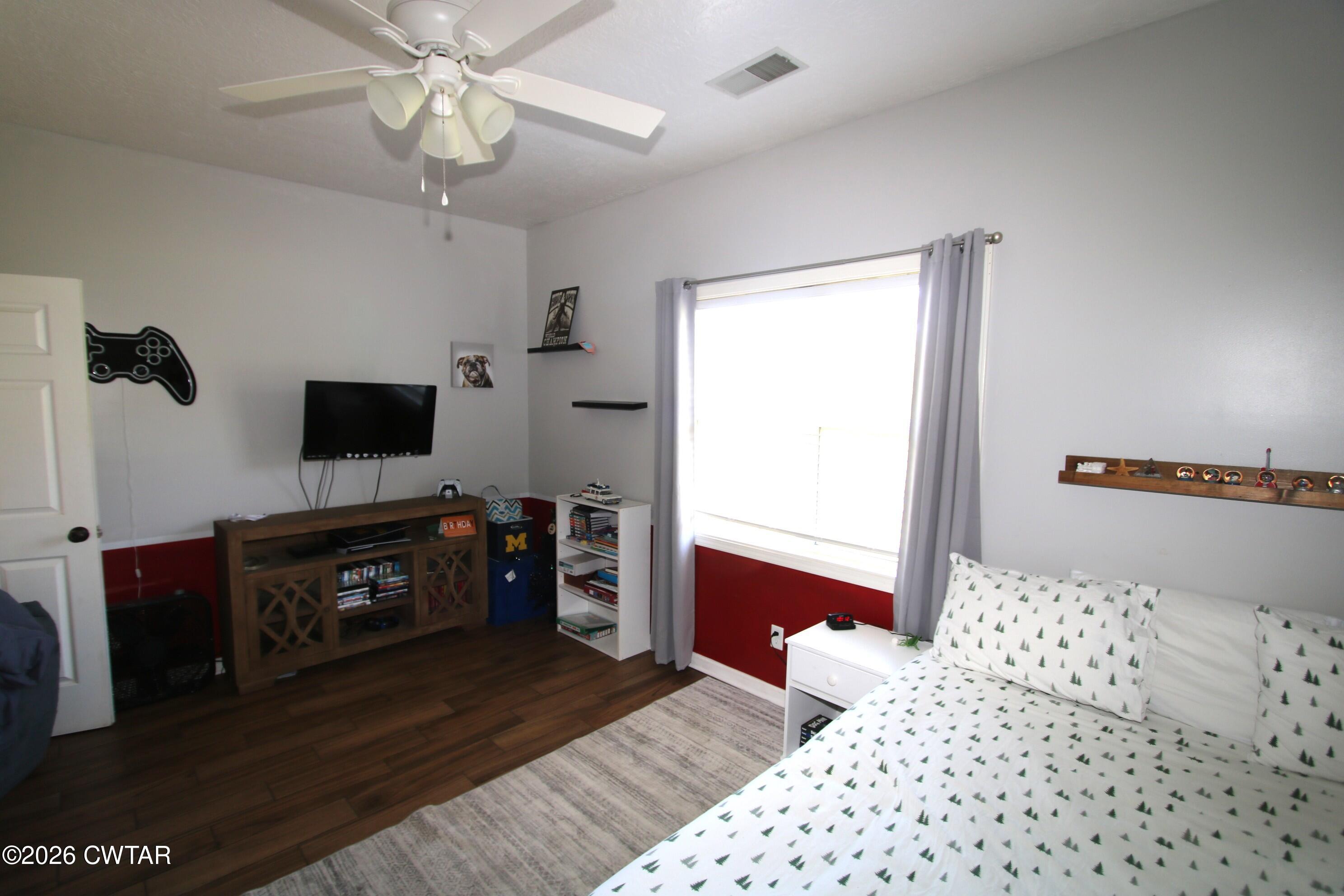 98 Browning Road Milan, TN 38358 - Photo 33 of 59 a bedroom with a bed and wooden floor