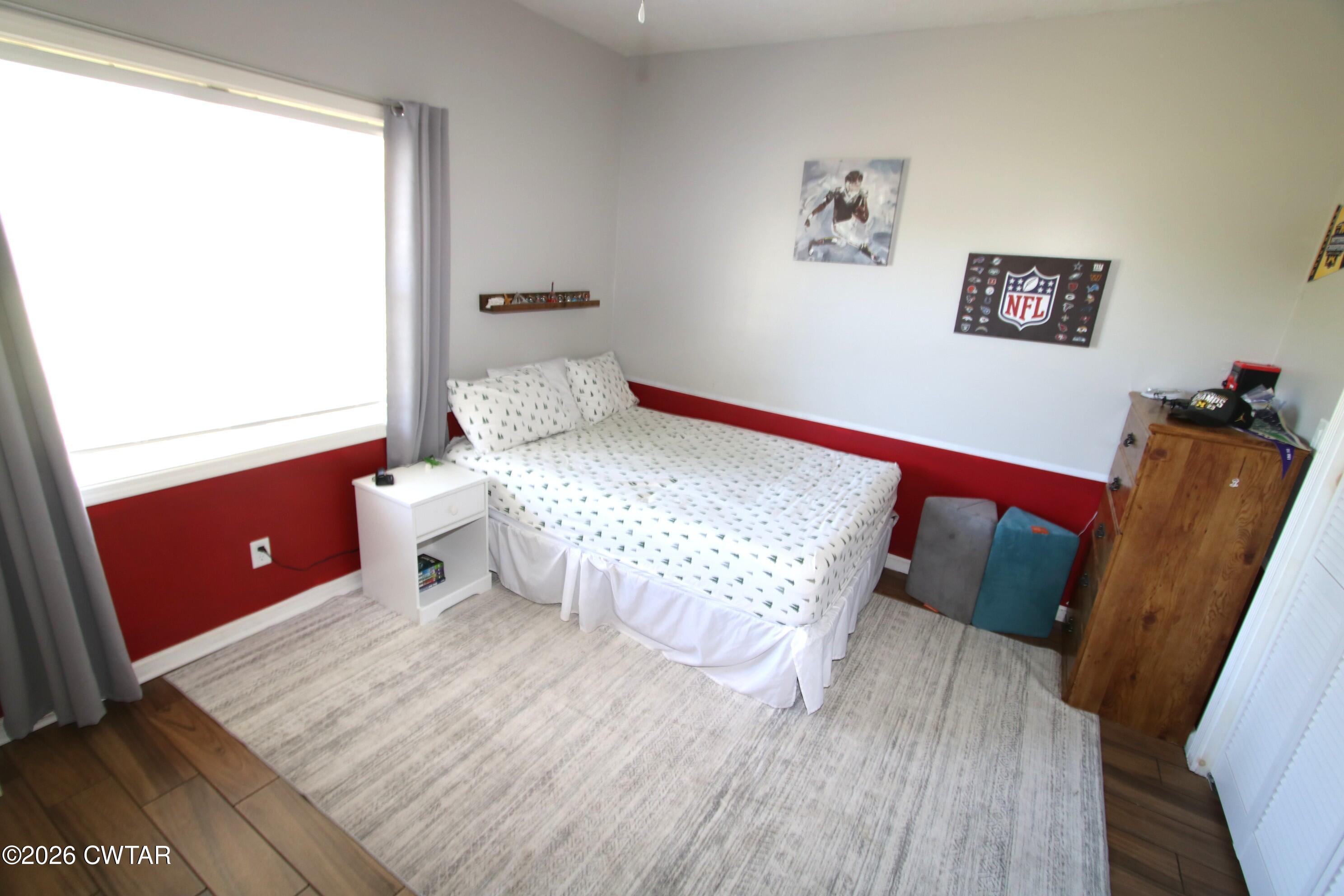 98 Browning Road Milan, TN 38358 - Photo 34 of 59 a bedroom with a bed and wooden floor