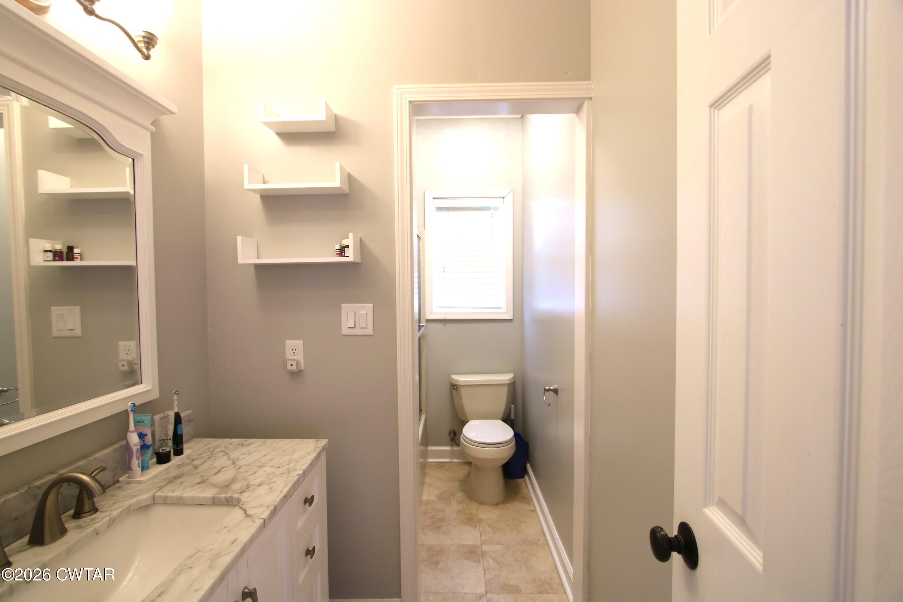98 Browning Road Milan, TN 38358 - Photo 36 of 59 a bathroom with a granite countertop sink toilet and shower