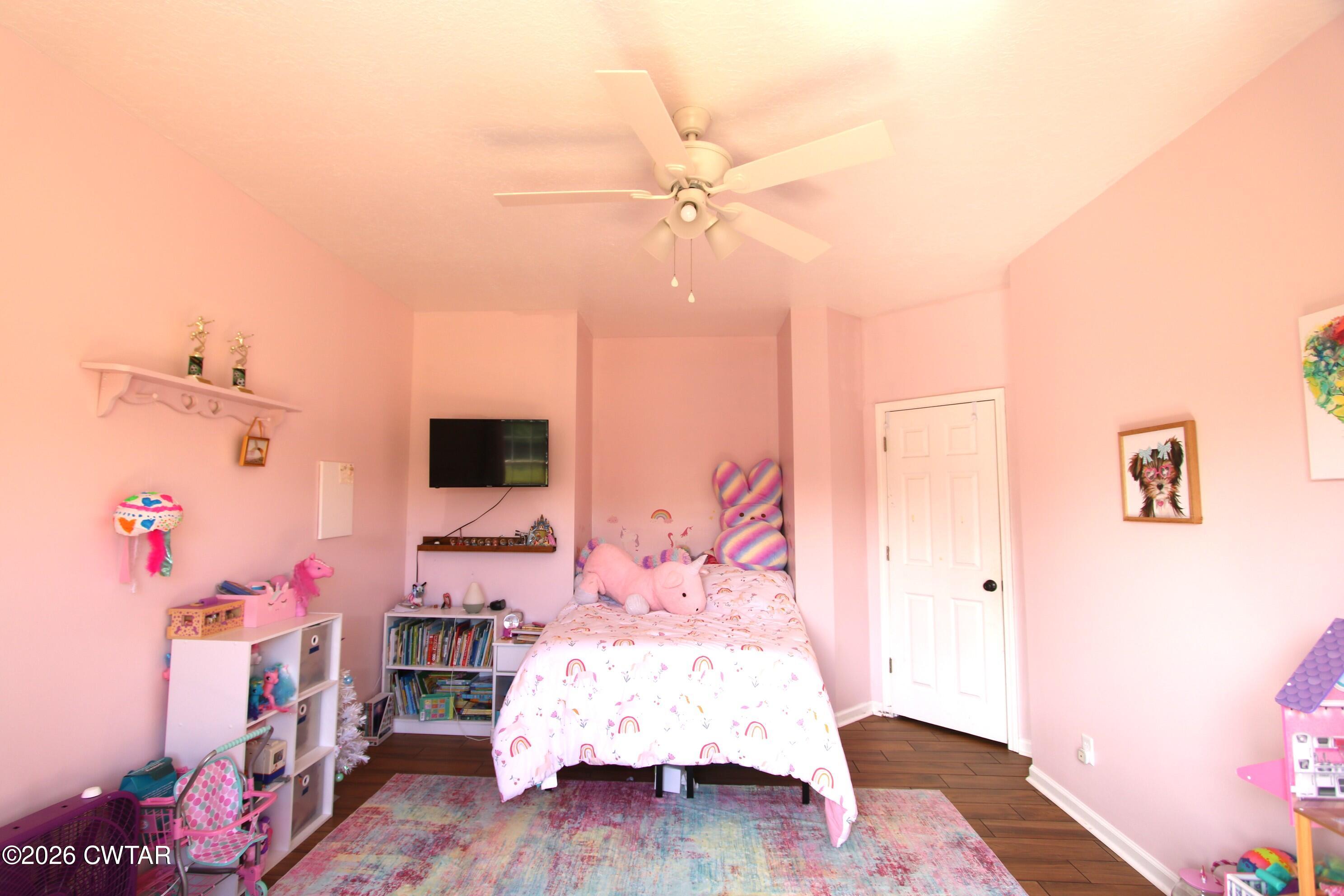 98 Browning Road Milan, TN 38358 - Photo 38 of 59 a bedroom with furniture and a wooden floor