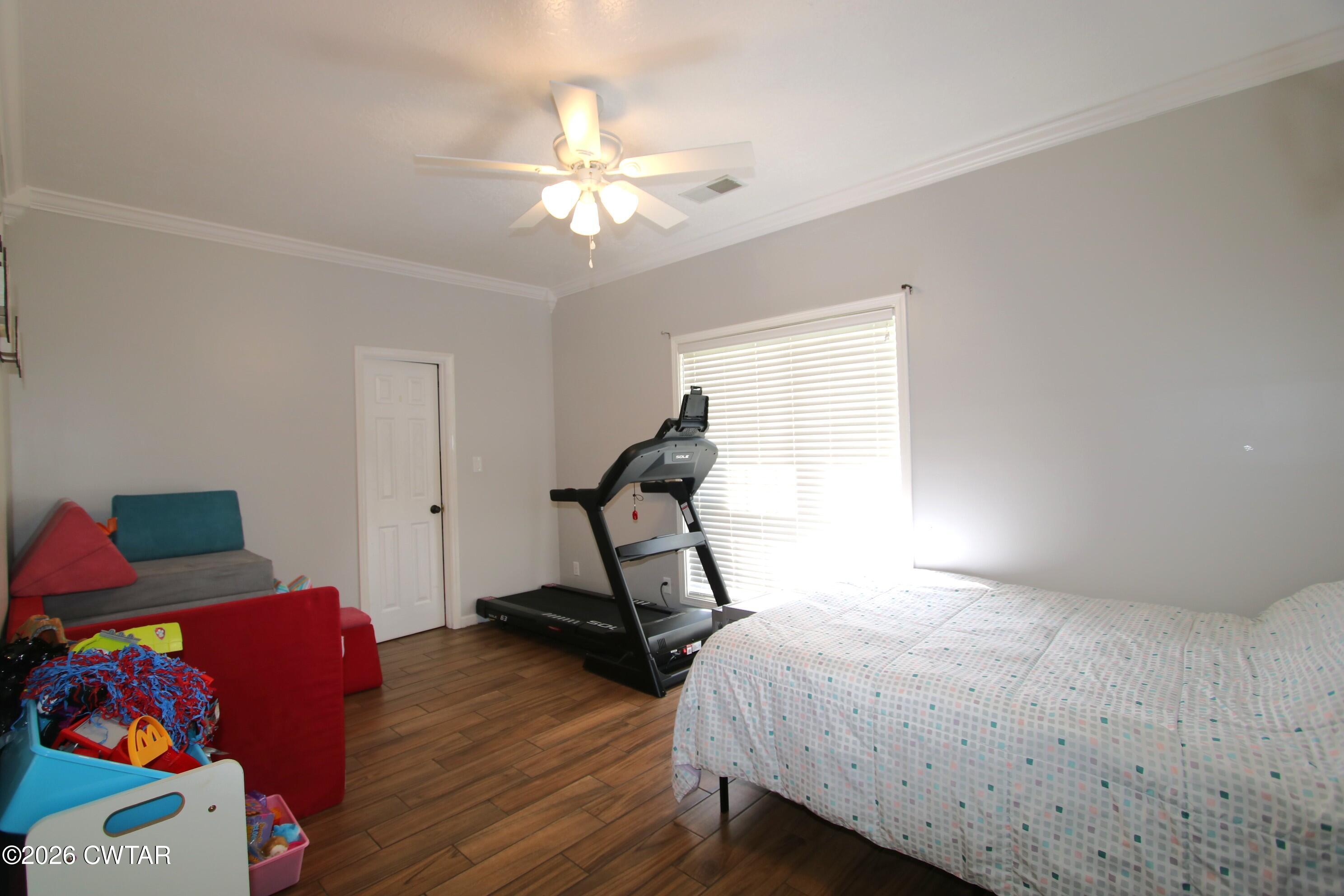 98 Browning Road Milan, TN 38358 - Photo 42 of 59 a bedroom with a bed and a chandelier