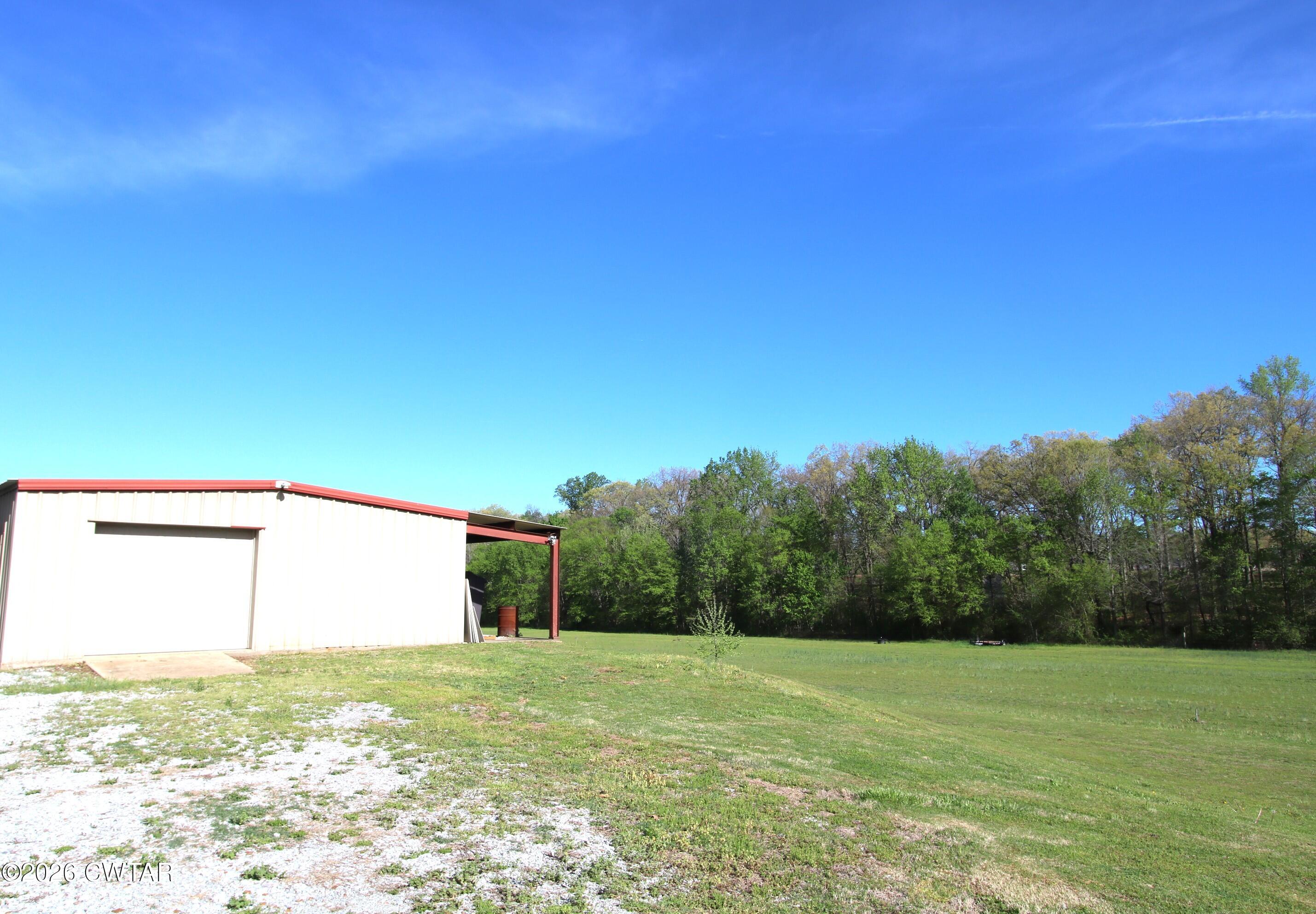98 Browning Road Milan, TN 38358 - Photo 51 of 59 a view of a big yard with an trees