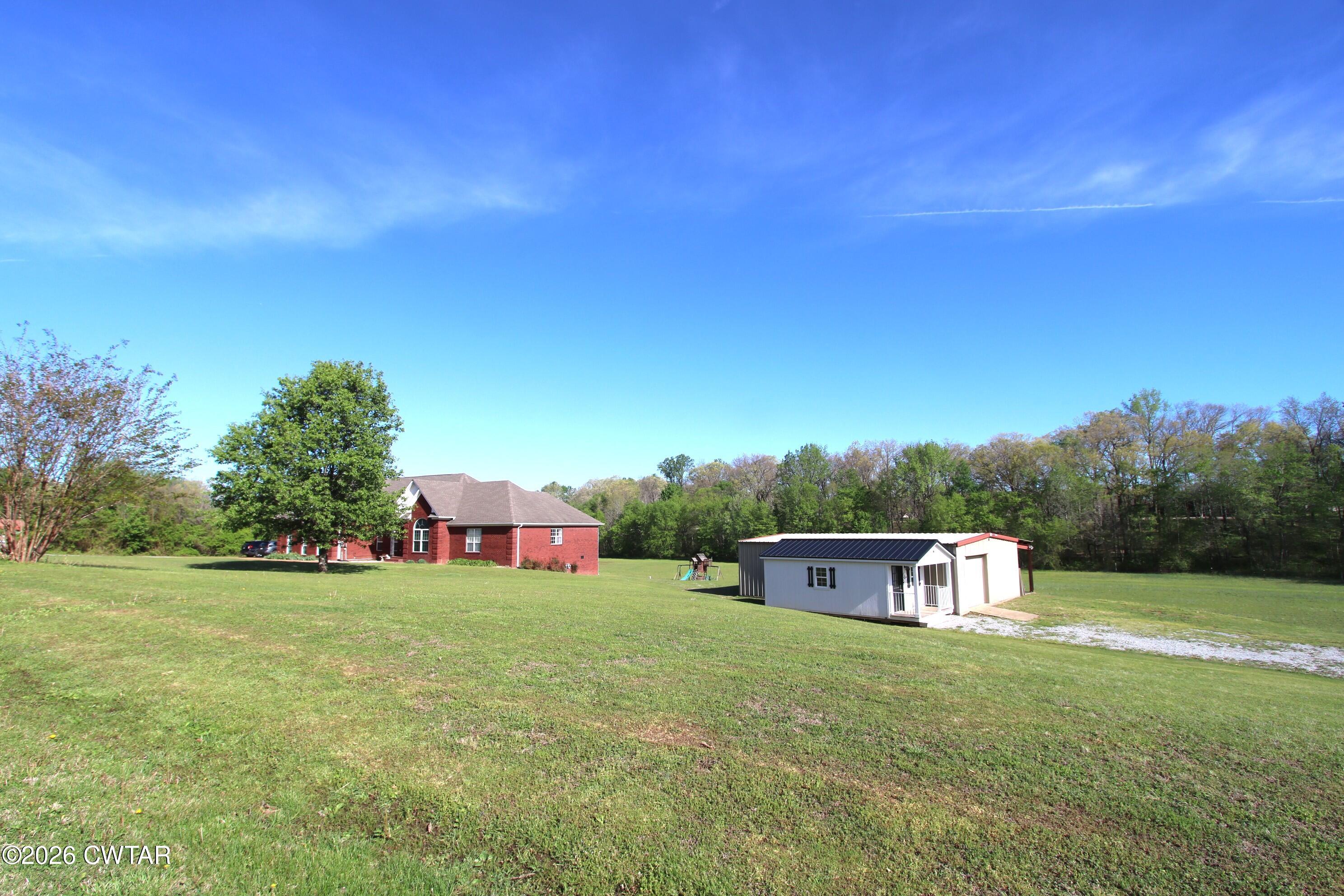 98 Browning Road Milan, TN 38358 - Photo 55 of 59 a view of a house with a big yard