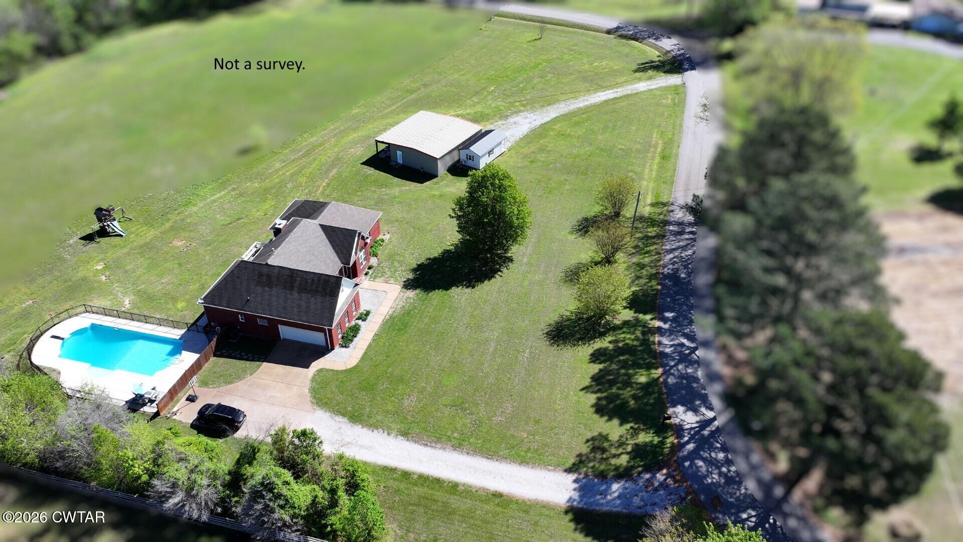 98 Browning Road Milan, TN 38358 - Photo 57 of 59 an aerial view of a house with a yard