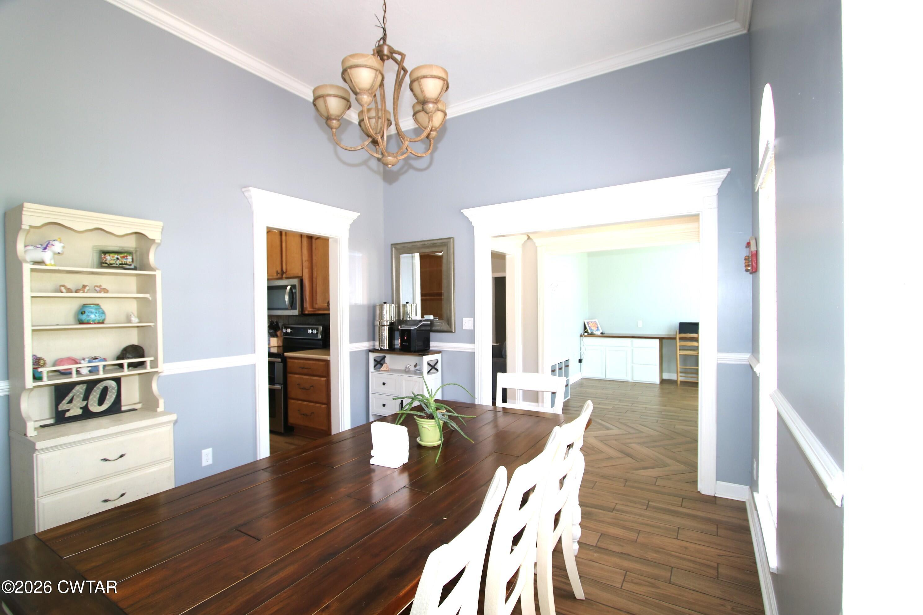 98 Browning Road Milan, TN 38358 - Photo 7 of 59 a view of a dining room and livingroom with furniture wooden floor a chandelier