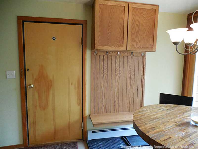 91300 Ryan Gulch Road, Unit 307 Silverthorne, CO 80498 - Photo 10 of 25 Dining Room. Dining area with front door and boot bench