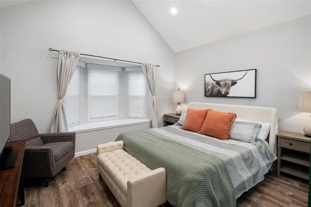 a bedroom with a bed and a couch