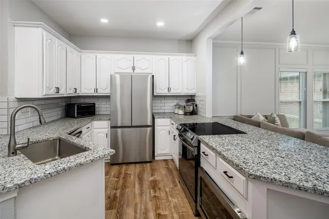 a kitchen with a sink stove and refrigerator