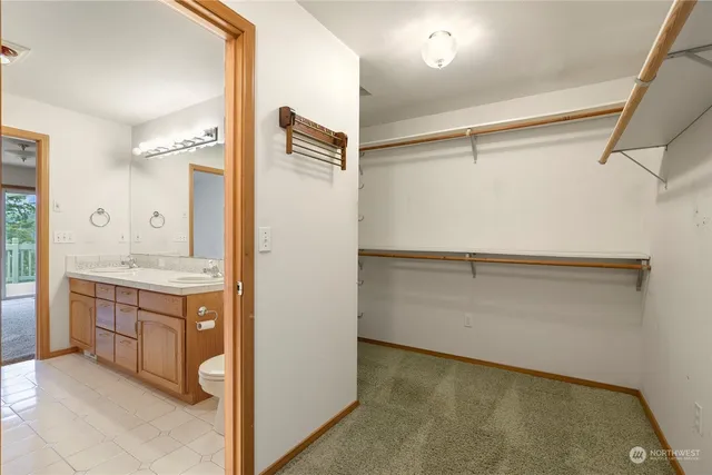 a bathroom with a granite countertop sink mirror and vanity