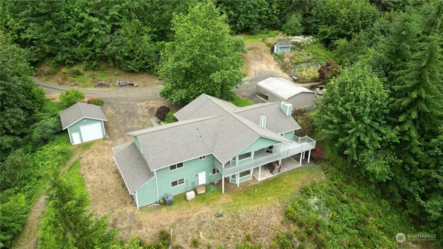an aerial view of a house with a yard