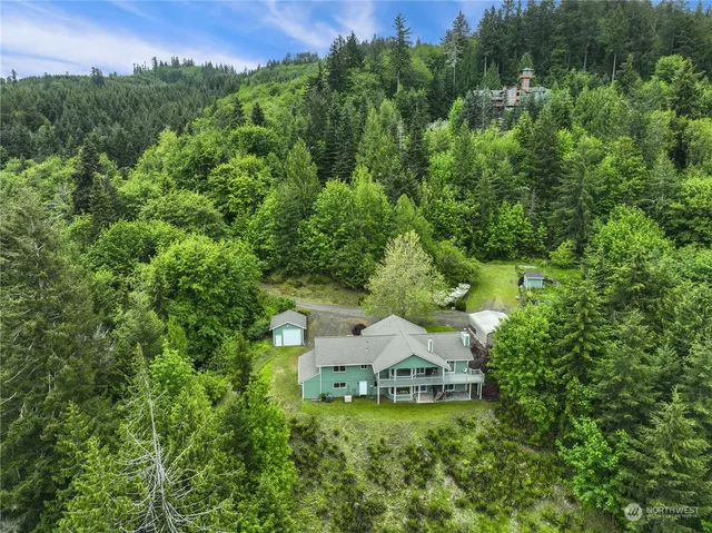 an aerial view of a house with a yard