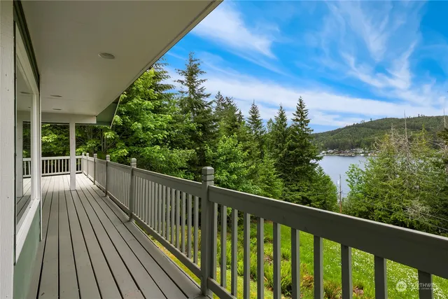 a view of balcony with wooden floor and fence