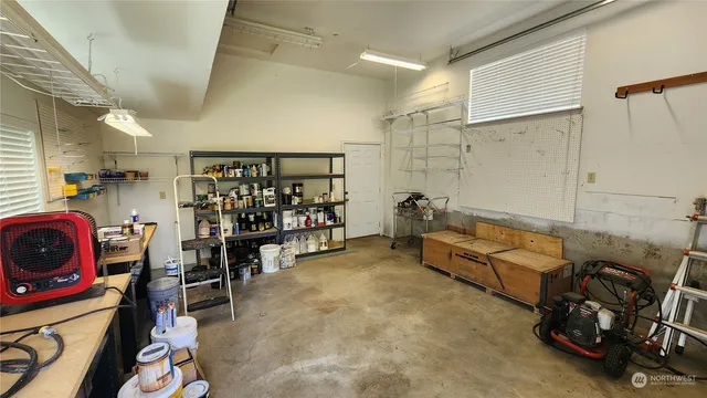 a garage with furniture and a ceiling fan