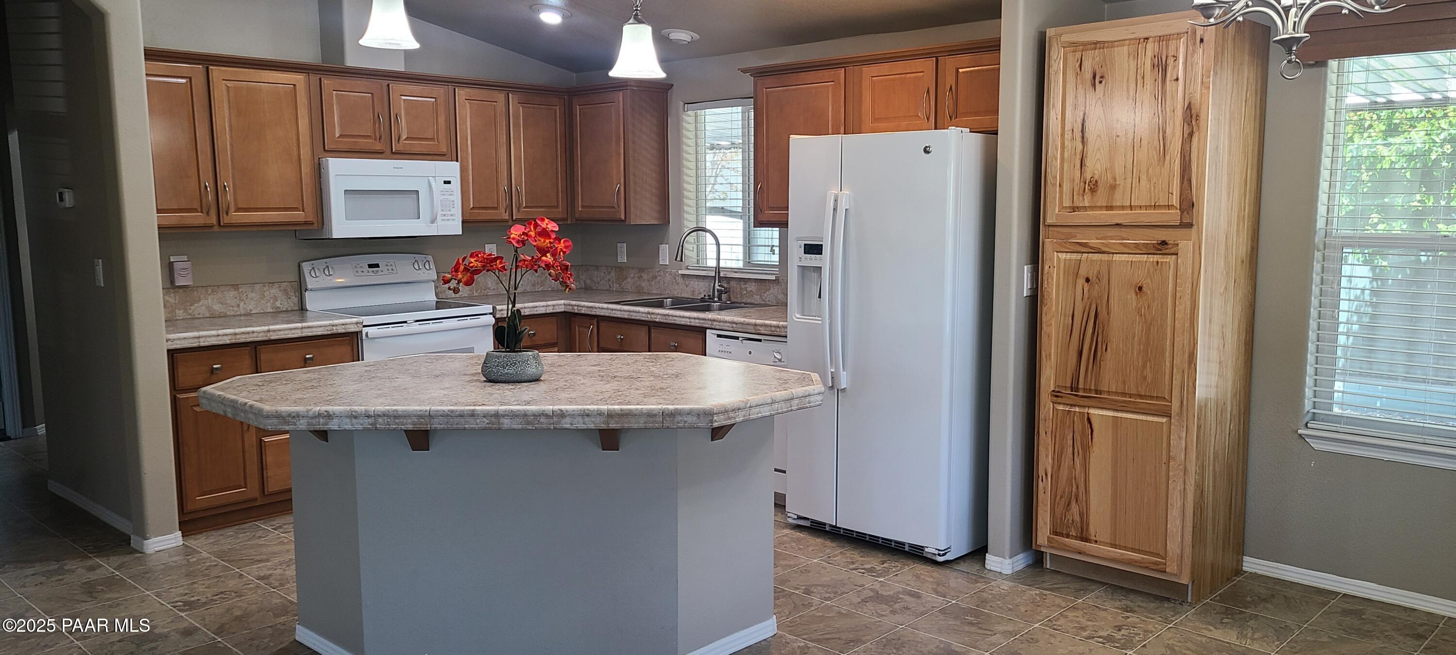 2146 Jackrabbit Drive, Unit 2146 Dewey, AZ 86327 - Photo 10 of 48 a kitchen with stainless steel appliances granite countertop a refrigerator and a sink