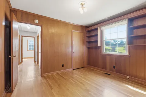 an empty room with windows and closet