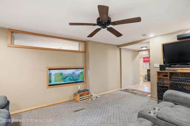 a kitchen with granite countertop white cabinets and black appliances