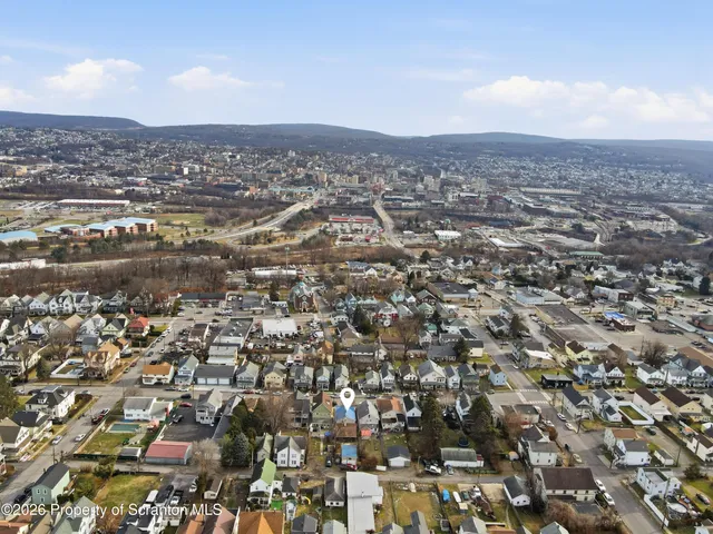 a room with lots of wooden furniture and chandelier