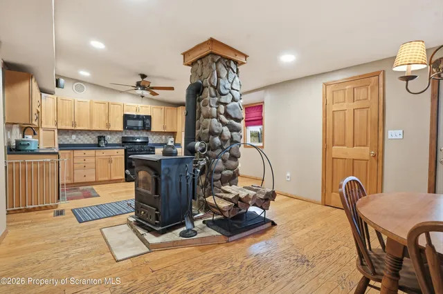 a kitchen with stainless steel appliances granite countertop a sink and wooden cabinets