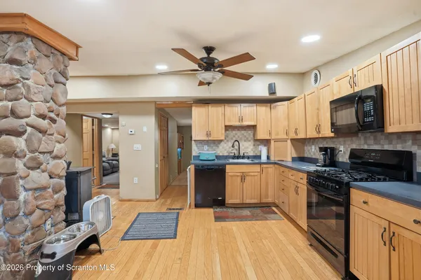 a kitchen with granite countertop a stove and a refrigerator