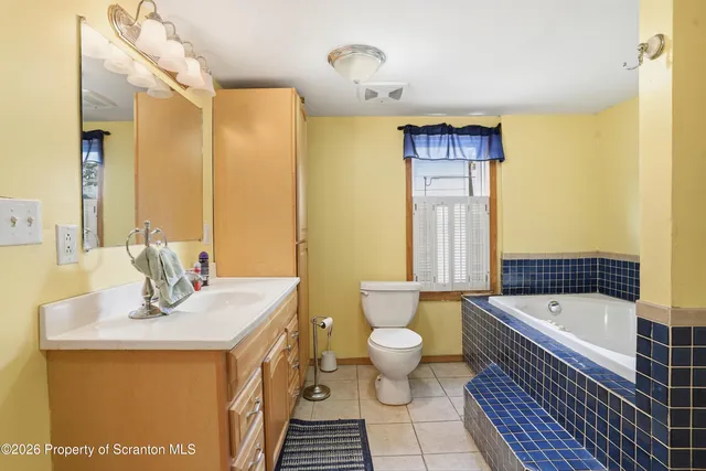 a view of small space with wooden floor and a window