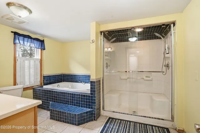 a front view of a house with a garden and plants