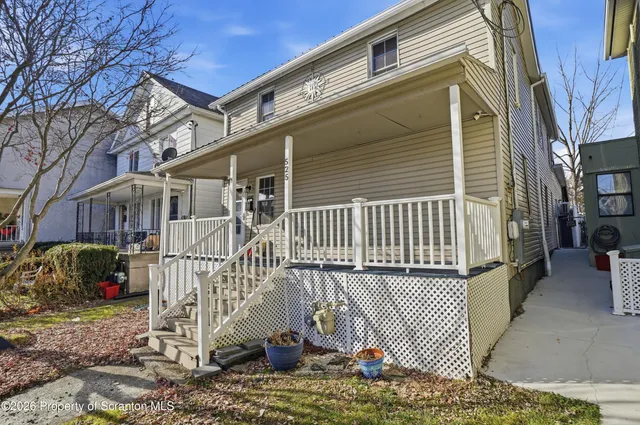 a view of a house with a wooden deck