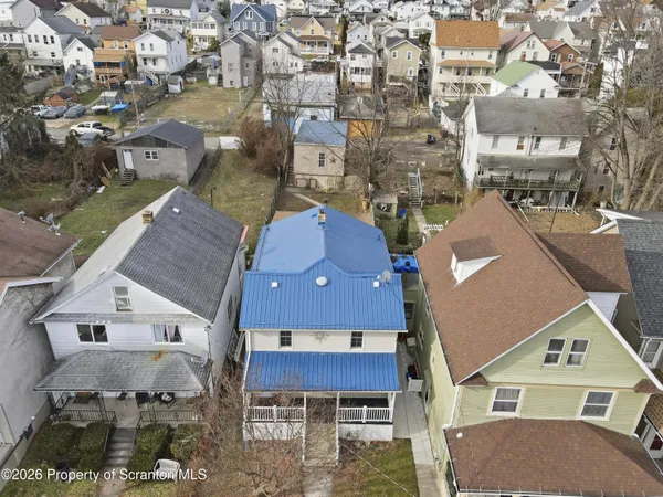 an aerial view of residential houses with outdoor space