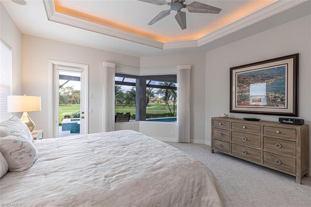 7984 Tiger Lily Drive Naples, FL 34113 - Photo 19 of 45 a bedroom with a bed and a dresser