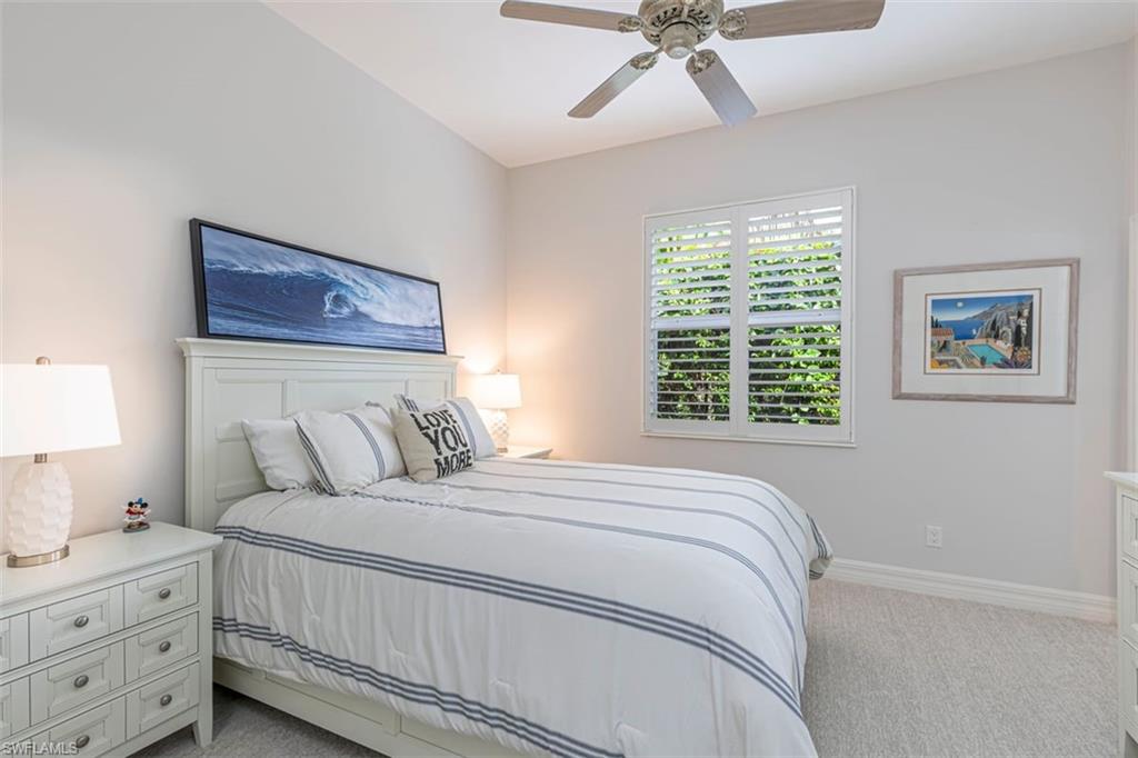 7984 Tiger Lily Drive Naples, FL 34113 - Photo 23 of 45 a bedroom with a bed and a window