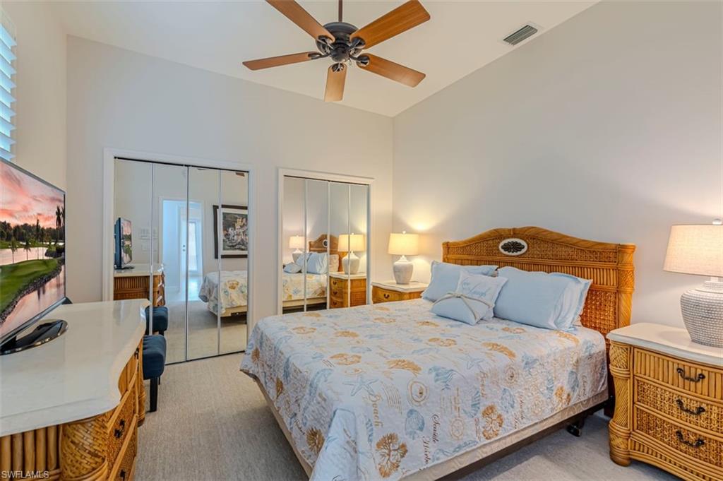 7984 Tiger Lily Drive Naples, FL 34113 - Photo 26 of 45 a bedroom with a bed and a flat tv screen on dresser