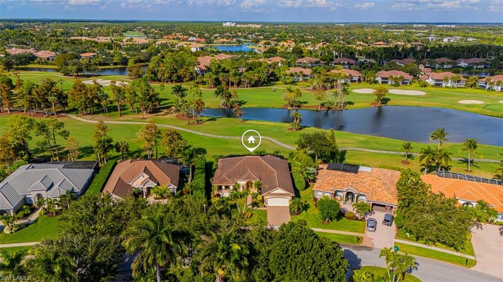 7984 Tiger Lily Drive Naples, FL 34113 - Photo 37 of 45 an aerial view of a house with a lake view