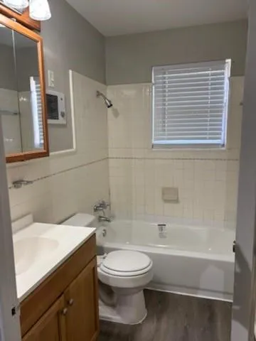 a bathroom with a toilet a sink and bathtub