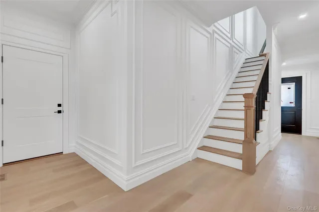 a view of a room with wooden floor and entryway