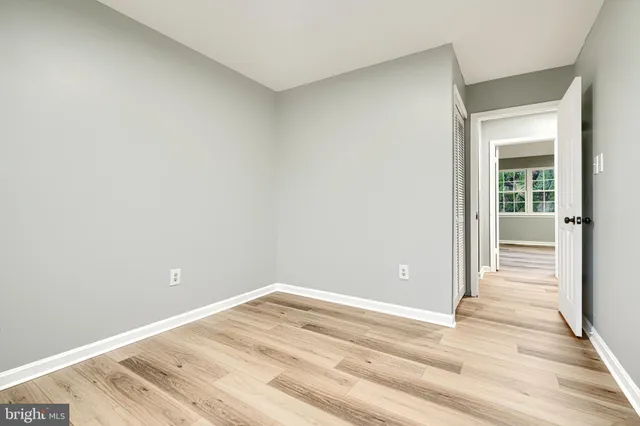 a view of a room with wooden floor and entryway