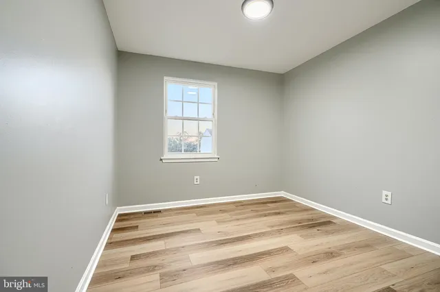 a view of a room with wooden floor and windows