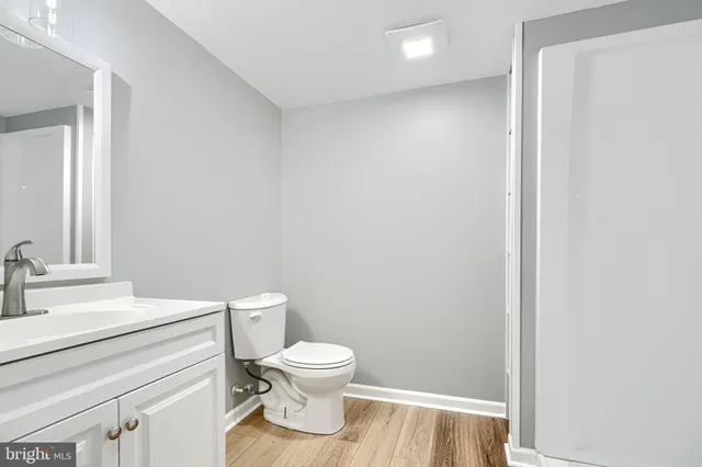 a white toilet sitting next to a bathroom sink