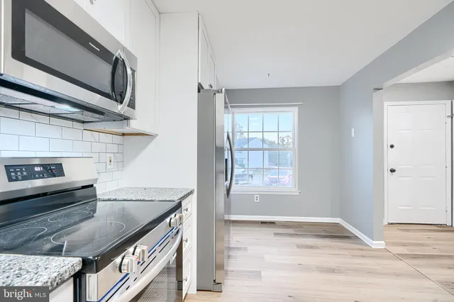 a view of a kitchen cabinets and a kitchen counter top space