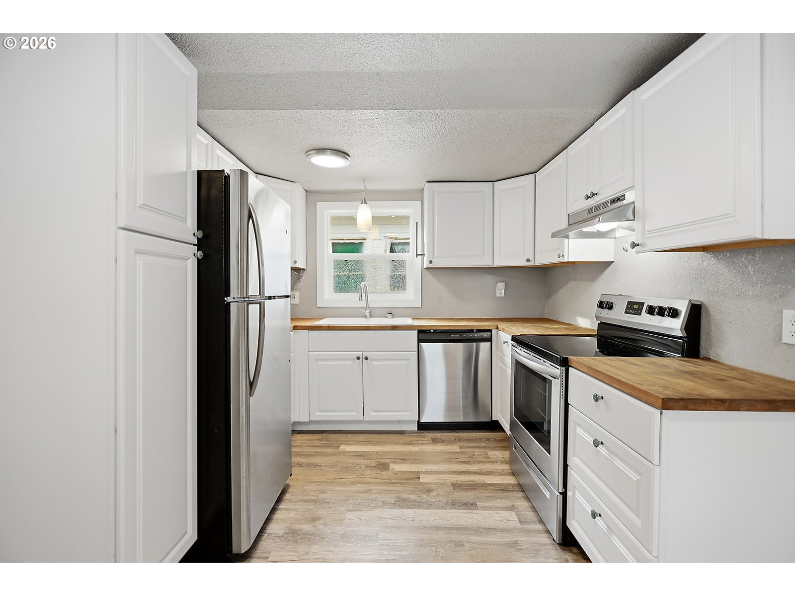 417 East Court Street Goldendale, WA 98620 - Photo 16 of 38 a kitchen with stainless steel appliances granite countertop a refrigerator sink and cabinets