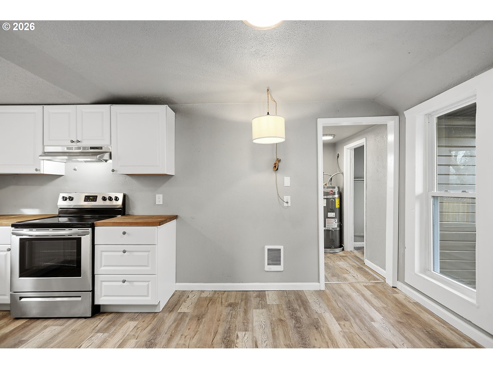 417 East Court Street Goldendale, WA 98620 - Photo 17 of 38 a kitchen with stainless steel appliances granite countertop a stove a sink and a refrigerator with white cabinets
