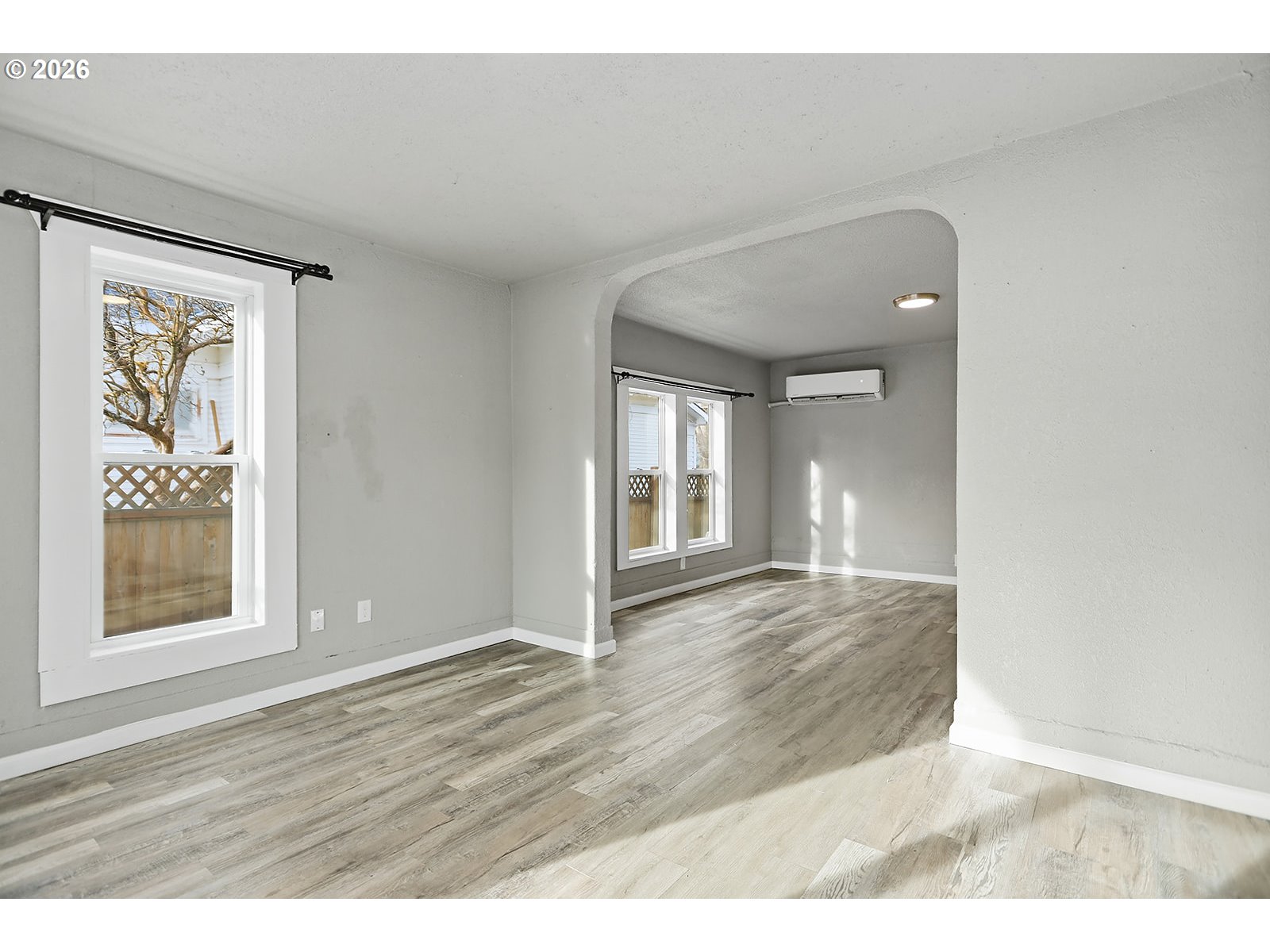417 East Court Street Goldendale, WA 98620 - Photo 3 of 38 a view of an empty room with wooden floor and a window