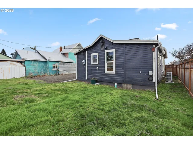 a view of a backyard with wooden fence