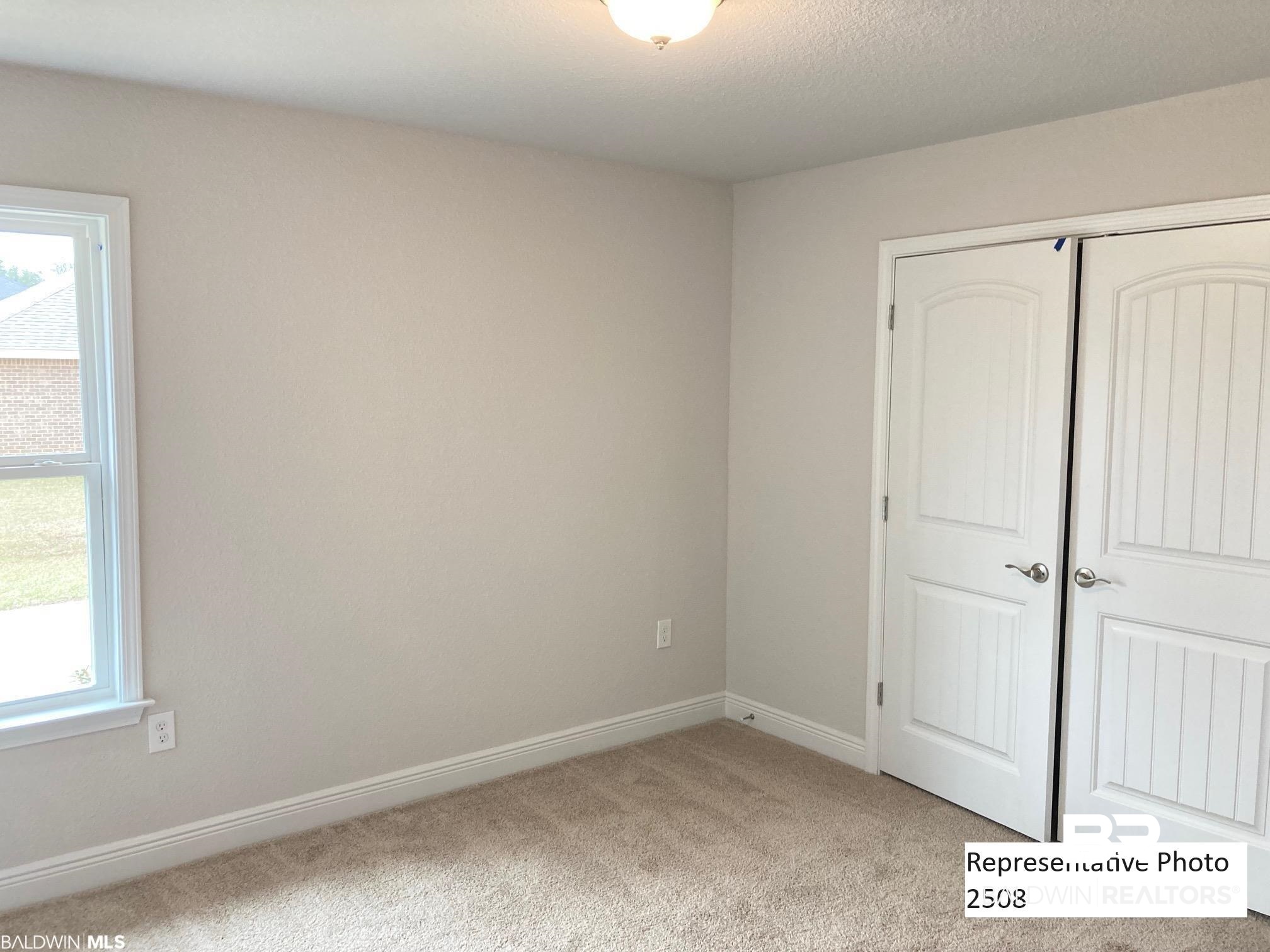 2201 Pollard Road Daphne, AL 36526 - Photo 10 of 15 Unfurnished bedroom with a closet and light colored carpet