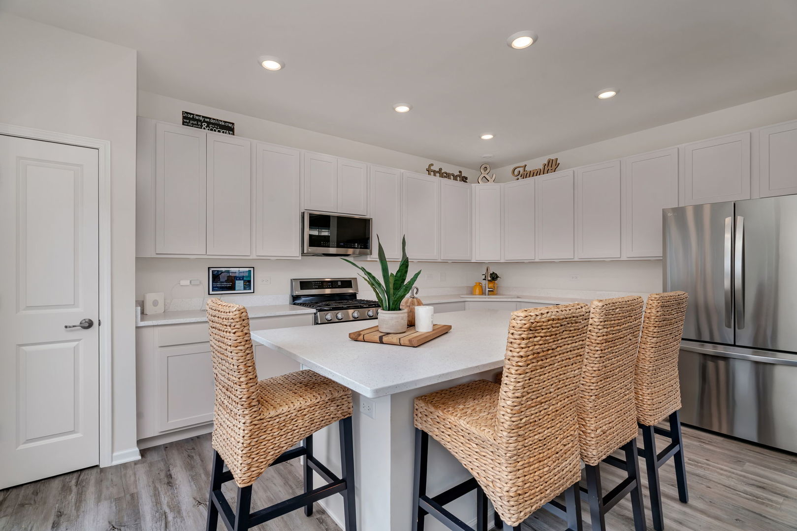2108 Pembridge Lane Joliet, IL 60431 - Photo 12 of 35 a kitchen with stainless steel appliances granite countertop a dining table chairs refrigerator and microwave