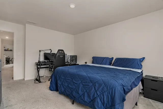 a bedroom with a bed and a table