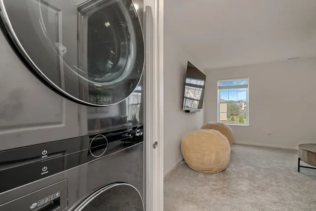 a view of a livingroom with wooden floor and a sink