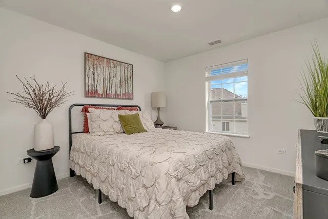 a bedroom with bed and window