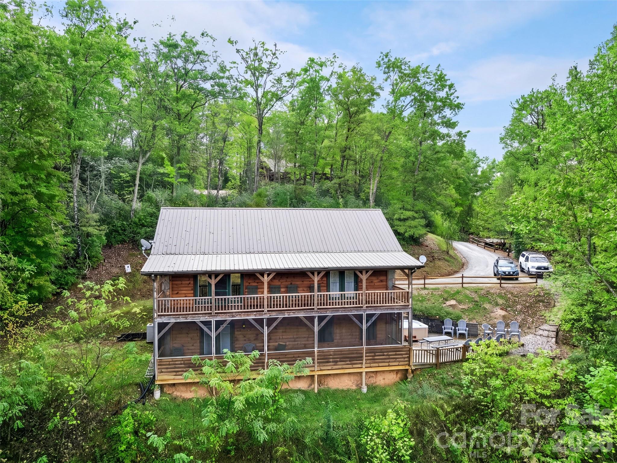 235 Soaring Eagle Road Bryson City, NC 28713 - Photo 2 of 42 an aerial view of a house with a yard table and chairs