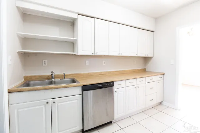 a kitchen with white cabinets and a sink